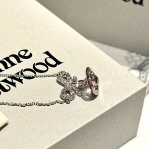 Vivian pink bow planet necklace